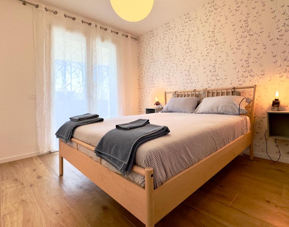 Camera matrimoniale con carta da parati a puntini e letto in legno